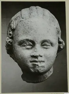 Sculpted head from Mersinaki with curled hair above the forehead and ears, and a short neck stump