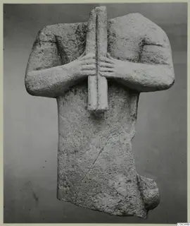Limestone figure fragment from Kition, arms crossed over the chest and hands gripping a vertical bar