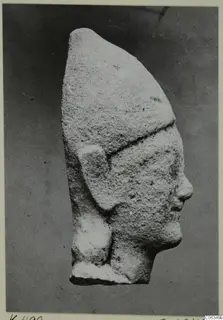 Limestone head statue from Kition, seen in profile facing right, with a tall headdress and a broken flat base.