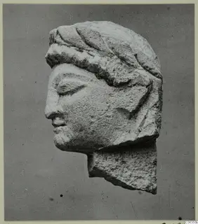 Limestone head statuette from Kition, shown in left profile with closed eyes and a band across the hair