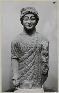 Limestone statue of a standing figure with a wreath around the head, from Kition