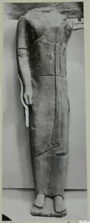 Headless limestone standing figure in a long garment, from Kition