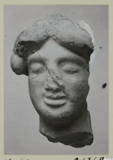 Terracotta head of a figure with closed eyes and thick hair, broken at the neck, from Vouni
