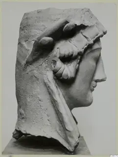 Right profile of a female bust fragment from Vouni, pale and chipped, set on a plinth