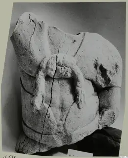 Limestone sculpture fragment from Vouni with a bent projecting limb on a rounded body