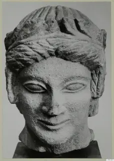Limestone head from Mersinaki, front view, with bands of combed hair and a slight smile