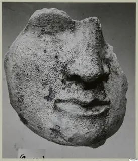 Limestone fragment of a face from Vouni, showing the nose and mouth