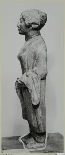 Limestone statuette of a standing female figure seen in profile, facing left, from Vouni