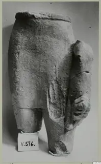 Limestone sculpture fragment, lower part of a figure with an arm projecting at the side, from Vouni