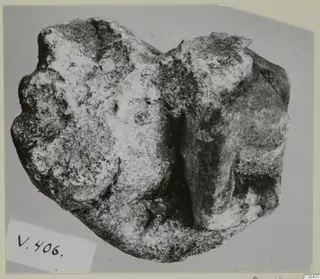 Fragment of a limestone sculpture, Vouni, seen from the front against a grey backdrop