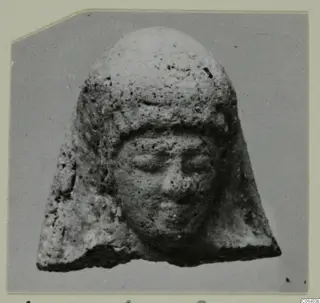 Small head of a figure in a close-fitting cap, with a rounded face, from Vouni