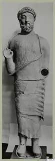 Statue of a standing bearded man with a leafy band in his hair and one fist raised, Cypro-Greek II
