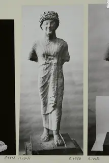Limestone statue of a standing figure from Kition, on a photo mount