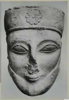 Limestone head of a figure with a tall cylindrical headdress and rosette, front view, Proto-Cypriote statue