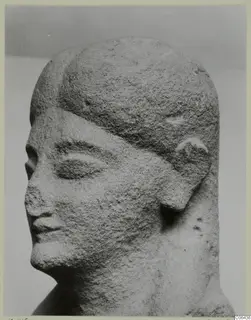 Limestone sculpture of a head from Kition, turned to the left, with narrowed eyes and a broad band across the brow
