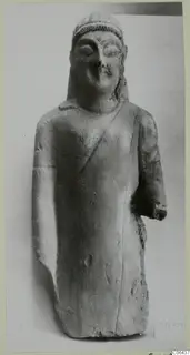 Limestone statuette from Kition of a standing figure in a long garment with a cap-like headdress