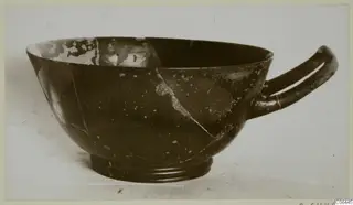 Black glazed bowl with a ring foot and one horizontal handle, a find from Vouni