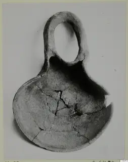 Terracotta lamp from Vouni with a tall loop handle and a broad bowl-shaped body