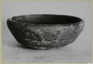 Side view of a coarse ware bowl with a notch broken from its rim, from Vouni