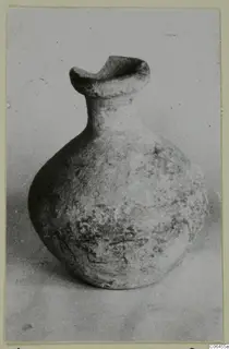 Plain White VI pottery vessel with a flared spout-like rim and rounded body, photographed on a plain background