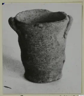 Miniature Plain White VI pottery vessel with two handles, from Vouni