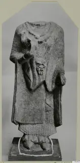 Headless limestone statue of a standing figure in a long garment, from Vouni
