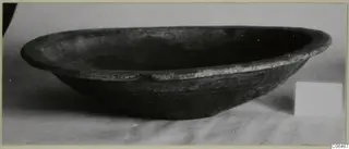 Coarse ware bowl from Vouni, shown from the side on a pale surface.