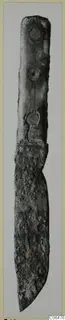 Iron knife with three rivets along its handle, photographed upright against a pale background.