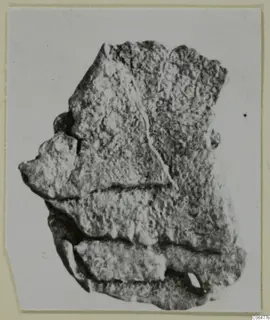 Fragment of lead from Kition with stepped layers and a crack running across its rough surface