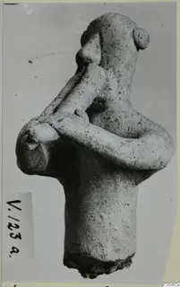 Terracotta figurine of a human figure with arms crossed over the chest, shown in side view, from Vouni.