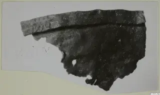 Bronze mounting fragment from Vouni, photographed on a pale card mount