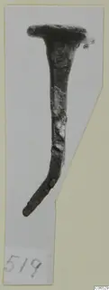 Bronze nail-like object with a flat head and bent shank, photographed on a cut-out card.
