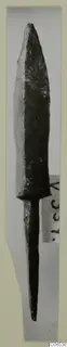 Bronze arrowhead from Vouni with a long slender tang, photographed upright on a card mount.