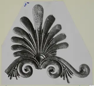 Bronze fragment of a fan of tongue-shaped leaves above spiral scrolls, from Vouni