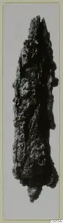 Heavily corroded iron weapon with a pointed upper end, photographed on a card mount