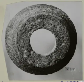Ring-shaped object with a large central hole, photographed face-on against a plain background.