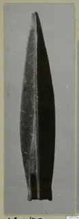Long pointed blade with a raised central ridge and a short squared base, arrowhead find from Vouni