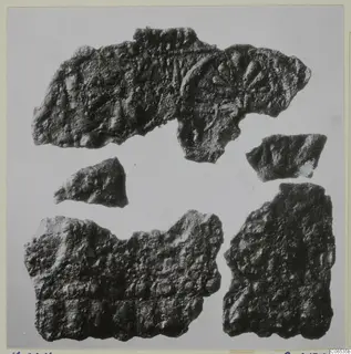Five fragments of corroded bronze sheet with raised ridges and rounded bosses, from Vouni.