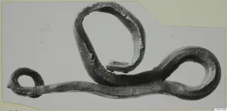 Bronze rod bent into several loops, shown on a mounted grey card, from Vouni
