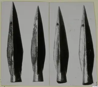 Four metal spearheads shown upright in two photographs mounted side by side on a card