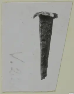 Metal nail with a flat head, shown on a card mount, from the Vouni metalwork series