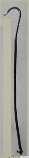 Bronze utensil handle from Vouni: a long thin rod with a hooked end, shown against a grey backdrop.