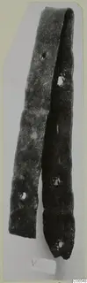 Long narrow bronze strip, bent back on itself, with several rivet holes along its length