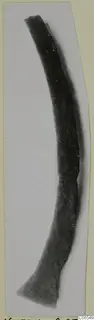 Curved bronze tool from Vouni, broken at the top and widening into a flat end at the bottom