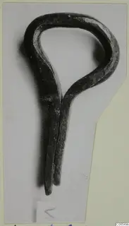 Bronze loop fragment with two tapering prongs, photographed on a mounted card