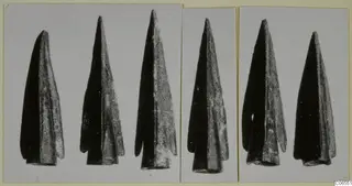 Six dark metal points from Vouni, photographed in three panels on a mounted card
