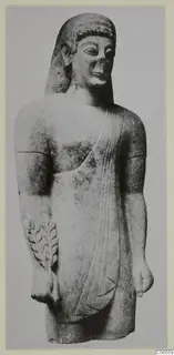 Limestone Neo-Cypriote statue of a standing figure with a leafy branch in relief, photographed from the front