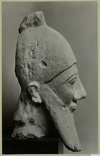 Limestone Proto-Cypriote head in side profile with a rounded cap and long projecting nose, on a dark stand