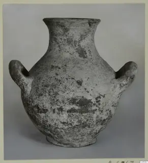 Plain white amphoriskos with a narrow flaring neck and two rounded handles, shown against a grey backdrop.