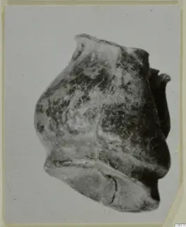 Lead fragment: an irregular, rounded lump with a flared lip at the top